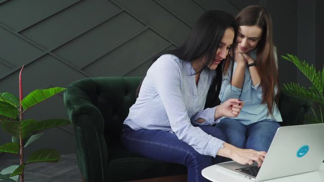 Two girlfriends shop online, black friday concept