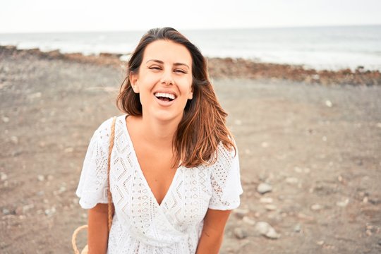 Young beautiful woman smiling happy enjoying summer vacation at black sand beach at Canary Islands