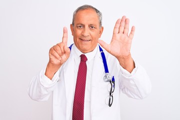 Senior grey-haired doctor man wearing stethoscope standing over isolated white background showing and pointing up with fingers number six while smiling confident and happy.