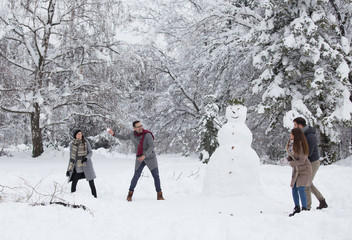 Friends having snowball fight