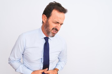 Middle age businessman wearing elegant tie standing over isolated white background with hand on stomach because nausea, painful disease feeling unwell. Ache concept.