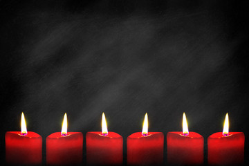 Red candles on blackboard background