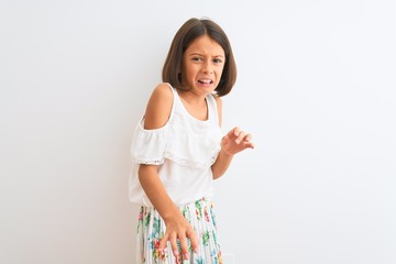 Young beautiful child girl wearing casual dress standing over isolated white background disgusted...