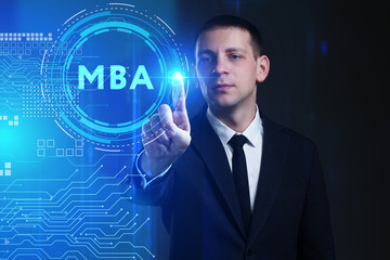 Business, Technology, Internet and network concept. Young businessman working on a virtual screen of the future and sees the inscription: MBA