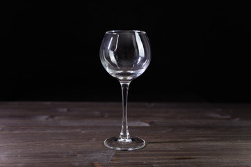 Photo of an empty wine glass. Nice color on a black background.