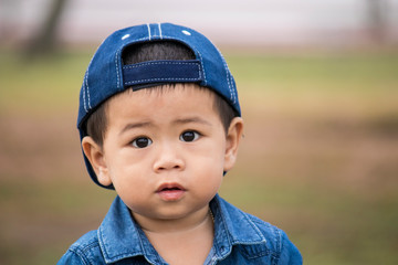 Cute Asian boy wearing a cap