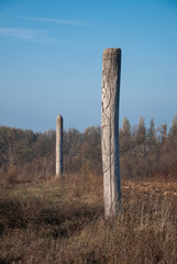Wooden idol Slavic god Svarog on a background of blue sky