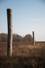 Wooden idol Slavic god Svarog on a background of blue sky