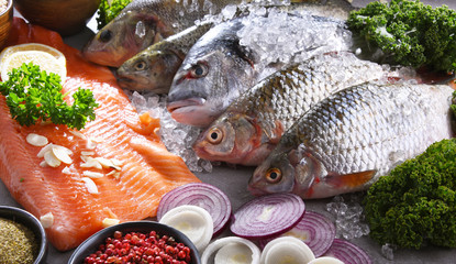 Different sorts of fish on kitchen table