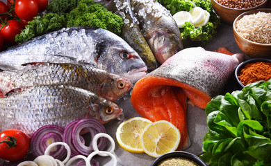Different sorts of fish on kitchen table
