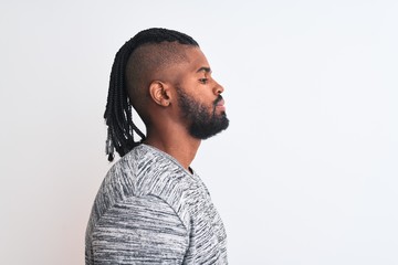 African american man with braids wearing grey sweater over isolated white background looking to...