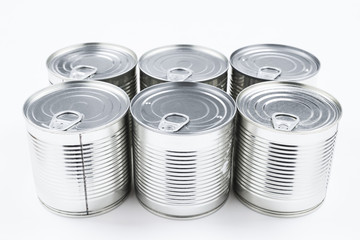 Group of silver canned food on white background.