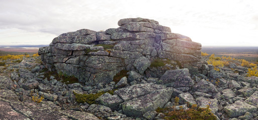 Cliff, mountains, stone wall and forest panoramic view in autumn. Fall colors - ruska time in Pyha-Nattanen. Urho Kekkonen National Park in north Finland. Laplan