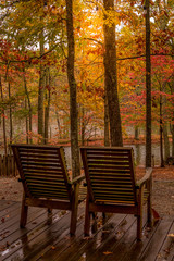 Fototapeta na wymiar two chairs in autumn park