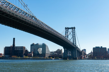 Fototapeta na wymiar The Williamsburg Bridge and the East River with the Williamsburg Brooklyn Skyline