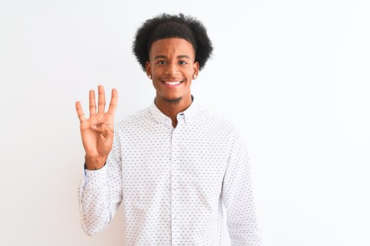 Young african american man wearing elegant shirt standing over isolated white background showing and pointing up with fingers number four while smiling confident and happy.
