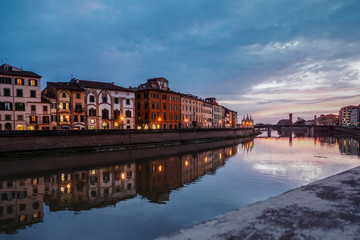 Fototapeta na wymiar Lungarnos in Pisa Italy, as well as Florence, is crossed by the Arno river. Pisan lungarnos, adorned with wonderful buildings and bridges are the most picturesque and famous places in Pisa