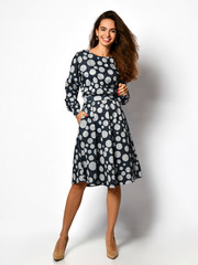 Fototapeta premium Young beautiful woman posing in new casual fashion dress full body on a white