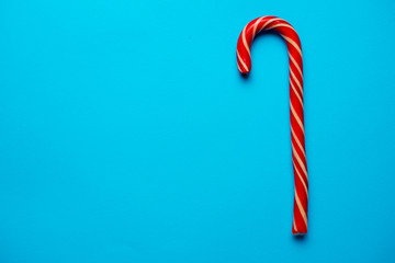 Christmas candy cane on blue background