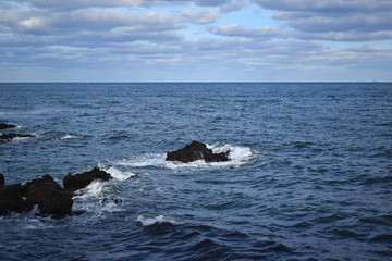 Fototapeta premium Rocky beach View Blue Sky Back ground