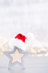 Christmas star, decor on bokeh silver background. Christmas or New Year minimal concept.