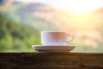 White cup and saucer on a background of nature