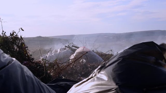 Trash and smoke representing a zone disaster and bad waste management. Planet problems concept. Nasty rubbish industry and dirty ecology on our planet. Destruction with lots of polluted materials 
