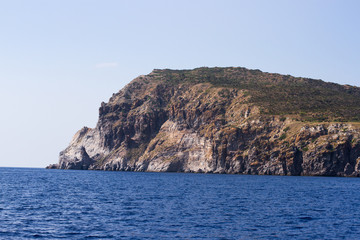 Island land bay seaside shore with a ship boat nearby