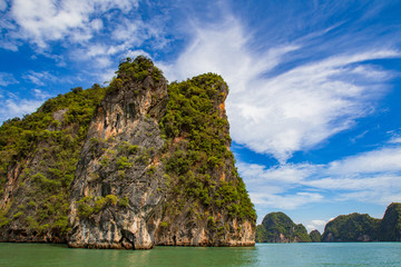 Thailand. Andaman Sea. Islands of the Andaman Sea near Phuket. Cruises to Thailand. Nature of Thailand. Landscape Southeast Asya. Rock in the water on the background of blue sky. Travels Andaman Sea