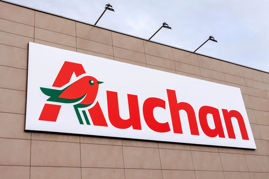 Coina, Portugal - October 23, 2019: Auchan logo or symbol in the Barreiro Planet Retail Park. Auchan is a French hypermarket, supermarket or superstore chain