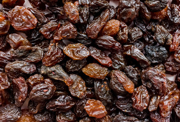 Top view of black raisins (sultana), dried fruits close-up. Closeup brown raisins. Food background