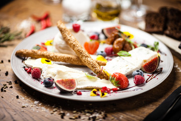 Cheese platter for two served on a plate in restaurant