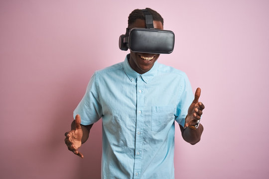 Young african american man playing virtual reality game using goggles