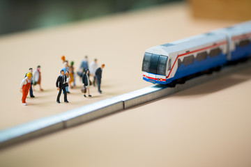 Miniature people waiting train at early morning rush hours. Thai public transportation concept