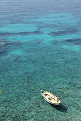 View of the beautiful azure bay in Croatia. The woman is sunbathing on the boat.