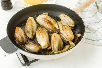 Braised chicory on the belgian way in a baking pan 