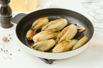 Braised chicory on the belgian way in a baking pan 