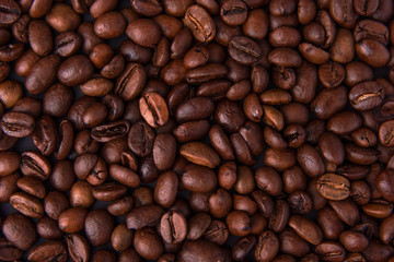 Beautiful composition of coffee beans, utensils for making coffee and decor in the form of almonds, dried slices of lemon, peanut and cinnamon on black and blue backgrounds.