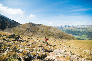 Young hiker walking on the Muragl valley in the area St.Moritz.