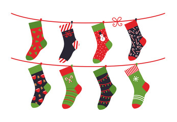 Cartoon socks. Children clothing elements with cute Christmas patterns drying sock collection on rope. Vector illustration winter holidays flat set green colour comfortable clothes