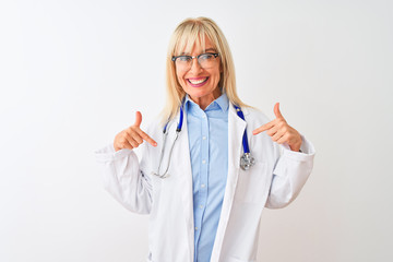 Middle age doctor woman wearing glasses and stethoscope over isolated white background looking...