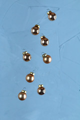 Golden Christmas decoration balls is falling, blue background