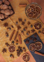 Beautiful festive composition of dried fruits and spices on a beautiful background with utensils with nuts, dried lemons, peanuts, almonds and acorns decorated with decor.