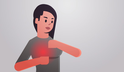 Young woman with breast pain touching her