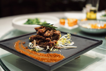 Roasted duck on a plate with shallow depth of field