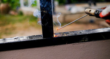 Welder Technician are welding steel with sparks