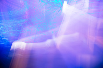 generated image of blue and violet light and stripes moving fast over background