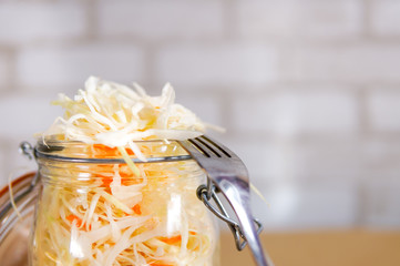  Fermented preserved vegetarian food concept. Homemade marinated cabbage, sauerkraut on white kitchen