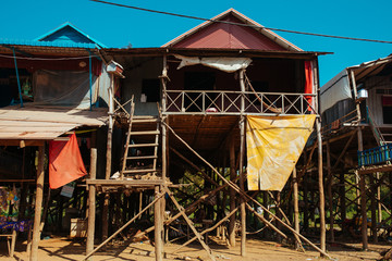 Floating village Residential houses on wooden poles and red soil road in Kampong Phluk Cambodia near Tonle Sap Lake