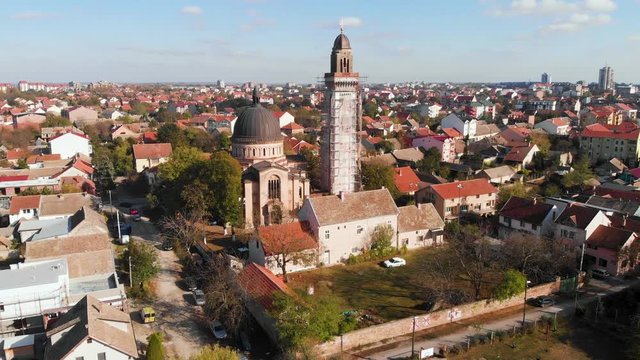 Amazing view of quiet suburb neighborhood with an orthodox church in a sunny day with light blue sky 